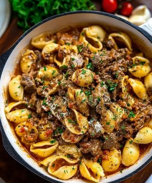 Creamy Beef Pasta for Cozy Nights, seasoned beef, tomato cream sauce, and fresh parsley.