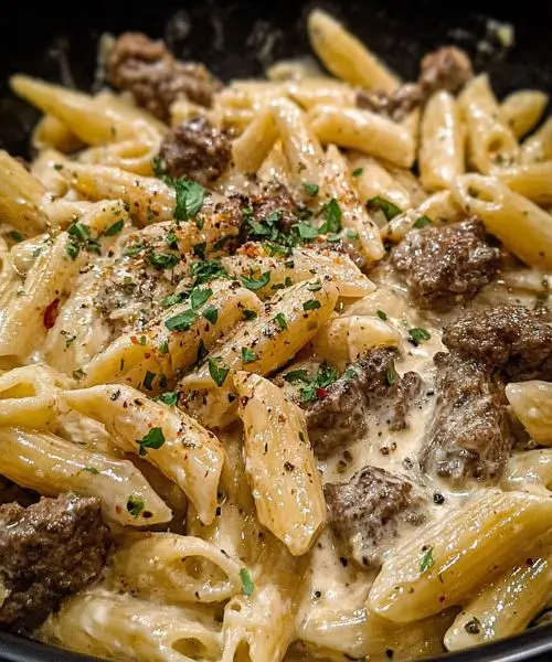 slow cooker creamy garlic beef pasta in crockpot