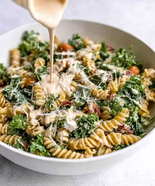 kale caesar pasta salad with parmesan and creamy dressing