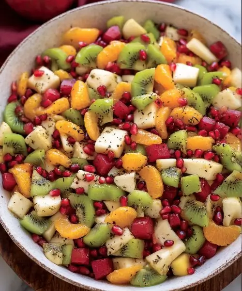 winter fruit salad with apples kiwi pomegranate and citrus