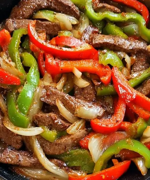 Pepper Steak with Bell Peppers and Onion in a skillet